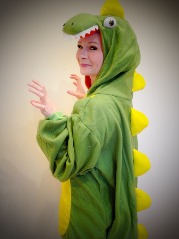 Lady dressed in a dinosaur onesie at Spellbound Parties